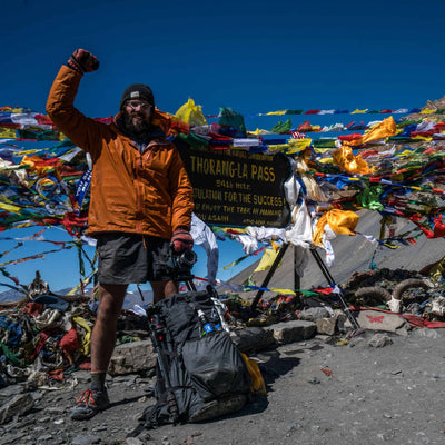 Individual posing with the Southwest 55 backpack in a mountainous terrain